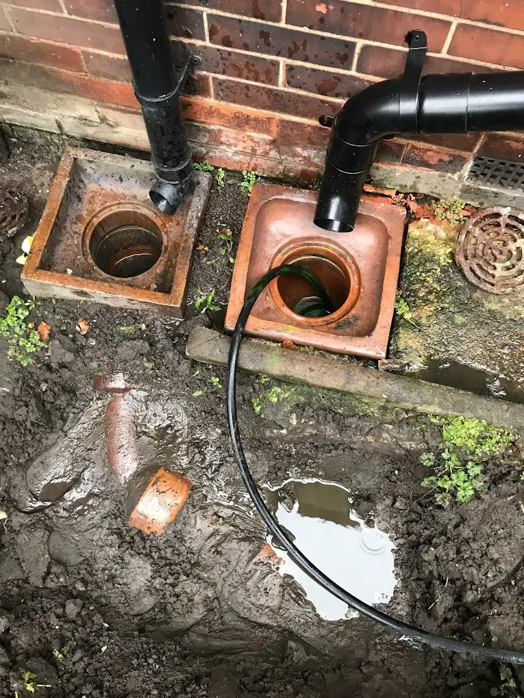 Professional drain unblocking or cleaning service being carried out on a residential gully drain in East Yorkshire.